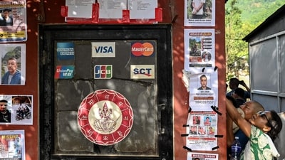 Family members check the lists of rescued and missing people at a bank ATM near Trishuli camp in the aftermath of flash floods in Nepal's Nuwakot district on August 30, 2026. (Representative Image/AFP) Family members check the lists of rescued and missing people at a bank ATM near Trishuli camp in the aftermath of flash floods in Nepal's Nuwakot district on August 30, 2026. (Representative Image/AFP)