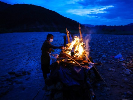 A relative of Prabita Roila, 32, who lost her life following deadly flash floods and a mudslide, lights her funeral pyre at the Suryamati River in Trishuli, Nuwakot district, Nepal, August 30, 2026. REUTERS/Athit Perawongmetha