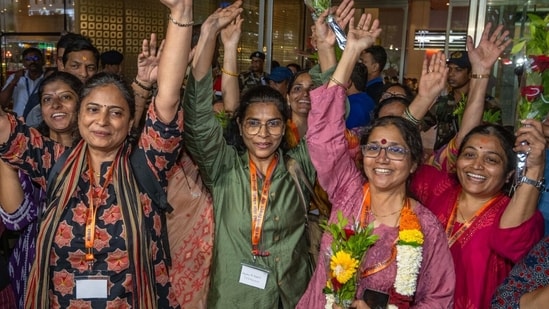 Relatives welcome 37 pilgrims from Raigad and Mumbai who were stranded in Nepal as they arrive safely at Mumbai airport today after returning from Kathmandu (Satish Bate/ Hindustan Times)