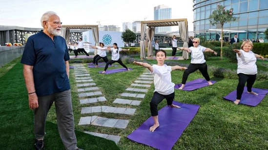 Prime Minister Narendra Modi views a yoga session organised by the Yoga Federation of Uzbekistan at the Hilton Tashkent City hotel during his two-day state visit, in Tashkent