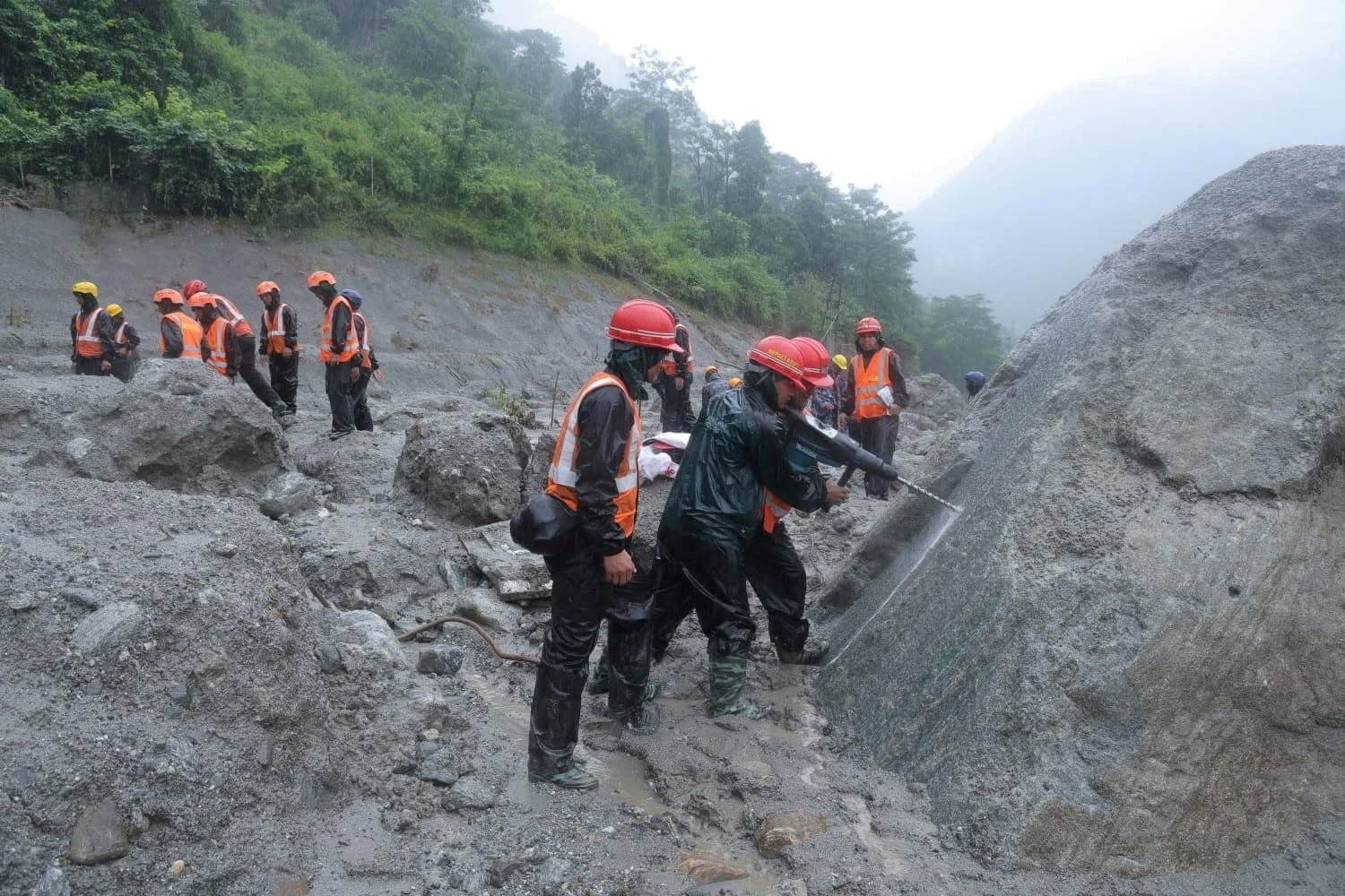 An undated handout photo of rescue workers taking part in a rescue operation near the tunnel of the Trishuli 3A Hydropower Project, following deadly flash floods and mudslides, in Rasuwa, Nepal. Reuters