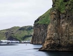 The entrance to the harbour of Heimaey, surrounded by steep volcanic cliffs in Iceland’s Westman Islands (Vestmannaeyjar), on August 26, 2026. The harbour is a key hub for the island’s fishing industry and maritime connections with mainland Iceland. 