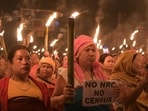 Imphal: Women take part in protest rally 'Meira Rally' as they hold flame torches demanding updation of the National Register of Citizens (NRC) before the Census in Manipur, at Khurai area, in Imphal on Aug. 21 (PTI FILE)