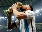Lionel Messi kisses the trophy as he celebrates winning the 2022 FIFA World Cup. (REUTERS)