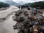 A drone view shows damaged buildings and houses covered in mud next to the Likhu River following deadly flash floods and mudslides, in Devighat, Nuwakot district, Nepal. 