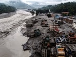 A drone view shows damaged buildings and houses covered in mud next to the Likhu River following deadly flash floods and mudslides, in Devighat, Nuwakot district, Nepal. 