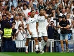 Jude Bellingham celebrates scoring their first goal with Trent Alexander.