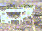 Despite the destruction after the floods, the green house stood erect, with its residents seen standing huddled in the balcony.