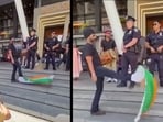 It appears as if the man has wrapped part of the national flag to his shoes, while continuously flaring and kicking the rest. 
