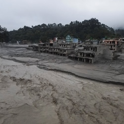 A drone view of the Trishuli river flowing past damaged buildings covered in mud after the deadly flash floods and mudslide, at Devighat, Nuwakot district, Nepal