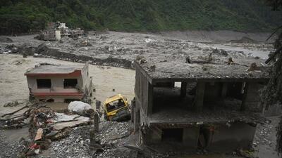 A vehicle and buildings near Trishuli river damaged and covered in mud following the August 26 deadly flash floods and a mudslide, at Betrawati Bazaar in Rasuwa district, Nepal. (REUTERS)