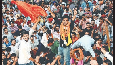 Ankit Bidhan (in black shirt) of ABVP celebrates with supporters after winning the presidential election of PUCSC at the Student Centre, Panjab University, in Chandigarh on Monday. (Ravi Kumar/Hindustan Times) Ankit Bidhan (in black shirt) of ABVP celebrates with supporters after winning the presidential election of PUCSC at the Student Centre, Panjab University, in Chandigarh on Monday. (Ravi Kumar/Hindustan Times)