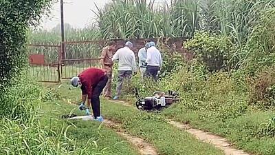 Forensic team and police personnel inspect the encounter site where a motorcycle lies on the ground in Shamli on Monday. (ANI VIDEO GRAB) Forensic team and police personnel inspect the encounter site where a motorcycle lies on the ground in Shamli on Monday. (ANI VIDEO GRAB)