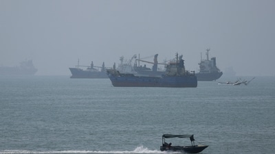 Vessels in the Strait of Hormuz are visible near the beach of Bandar Abbas, Iran. (REUTERS)
