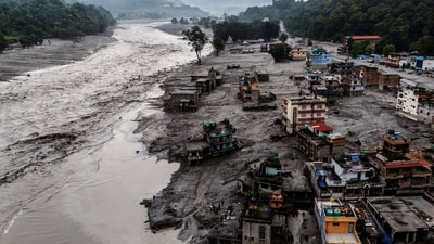 A drone view shows damaged buildings and houses covered in mud next to the Likhu River following deadly flash floods and mudslides, in Devighat, Nuwakot district, Nepal. (REUTERS)