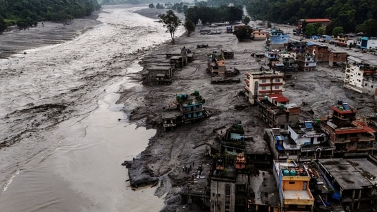 A drone view shows damaged buildings and houses covered in mud next to the Likhu River following deadly flash floods and mudslides, in Devighat, Nuwakot district, Nepal.
