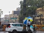 A traffic police personnel regulates traffic amid heavy rainfall, in Lucknow on Tuesday. (ANI)