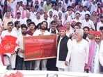 SP chief Akhilesh Yadav with workers and leaders at the party headquarters in Lucknow on Tuesday. (HT)