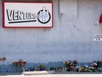 A growing memorial sits outside the Venture-N Bar in Tucson, Ariz., Tuesday, Sept. 1, 2026, for Vincent Siquieros and Cameron Capara, who were fatally shot in the parking lot of the gay bar shortly after midnight Monday. (AP Photo/Rebecca Noble)