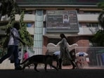 People watch the stock market index on a display screen on the facade of the Bombay Stock Exchange (BSE) building in Mumbai