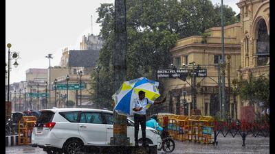 A traffic police personnel regulates traffic amid heavy rainfall, in Lucknow on Tuesday. (ANI)