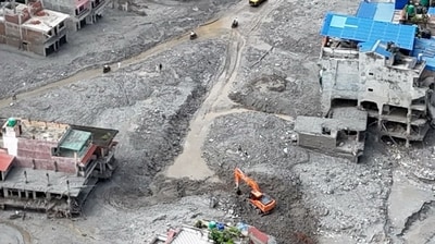 An aerial view shows a torrent of muddy water surging past houses and through the Trishuli River in the aftermath of flash floods at Trishuli Center in Nepal's Nuwakot district. (AFP)