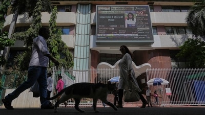 People watch the stock market index on a display screen on the facade of the Bombay Stock Exchange (BSE) building in Mumbai (AP/file)