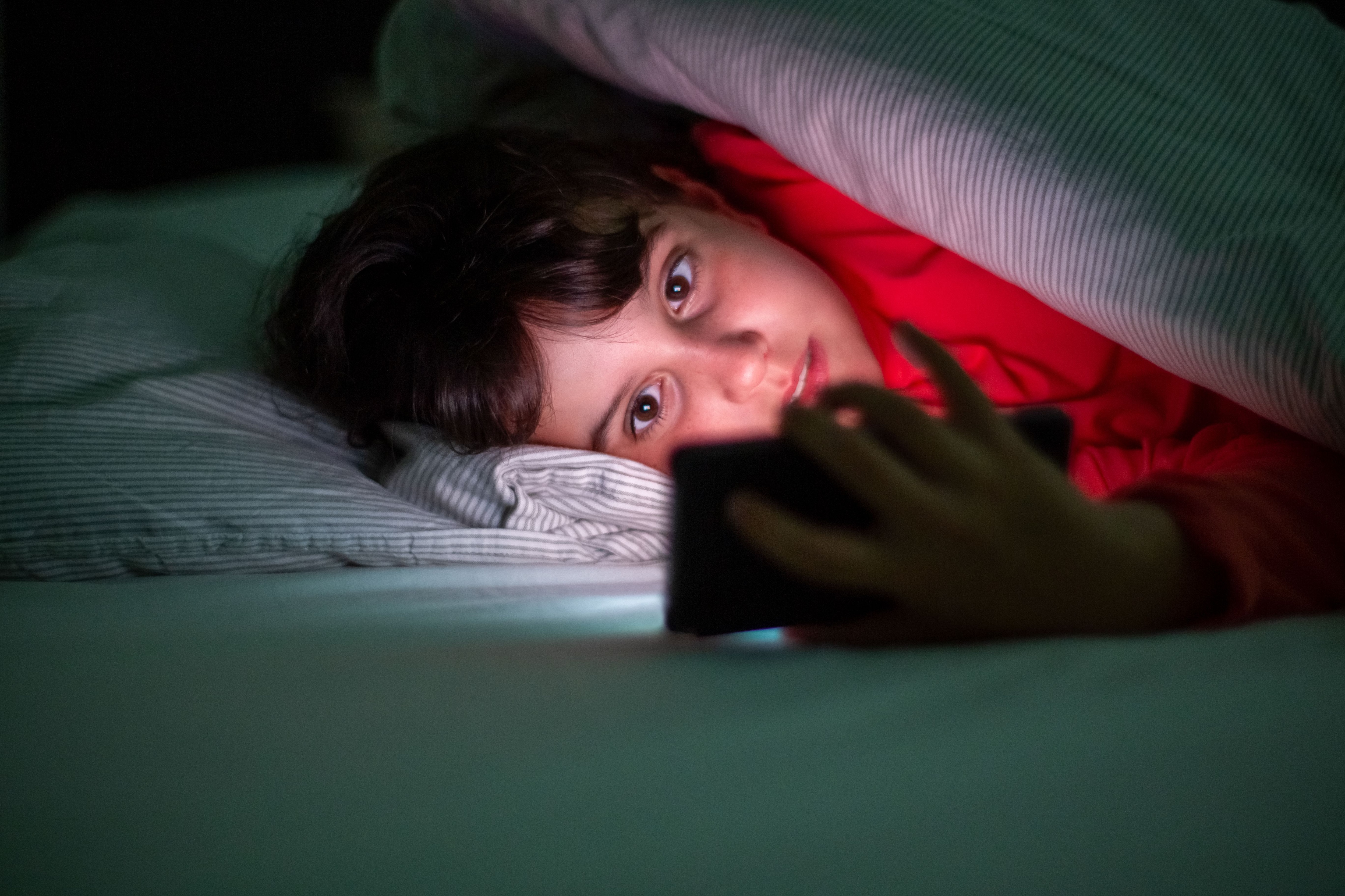 The health benefits of sleep are disrupted if a child keeps scrolling on their phone while in bed. (Pexel) The health benefits of sleep are disrupted if a child keeps scrolling on their phone while in bed. (Pexel)