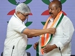 Rajendra Pal Gautam felicitates former AIMIM national spokesperson Syed Asim Waqar as he joins Congress at the AICC office, in New Delhi on  Wednesday. 
