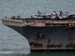The U.S. Navy Nimitz-class aircraft carrier USS Abraham Lincoln sails toward Laem Chabang Port before docking for a rest stop following a long deployment in the Middle East.