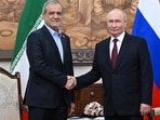 Russia's President Vladimir Putin and Iran's President Masoud Pezeshkian shake hands during a meeting on the sidelines of the Shanghai Cooperation Organisation (SCO) summit in Bishkek on September 1, 2026.
