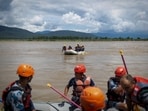 Members of the Armed Police Force (APF) conduct a search operation for bodies washed away by flash floods and a mudslide, in the Narayani River, Chitwan, Nepal.