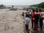 Rishikesh: People gather near an overflowing causeway as the swollen Bin river flows following incessant heavy rainfall, in Rishikesh, Uttarakhand on Tuesday, September 1.