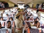 Police officers inspect a passenger bus during a special checking drive launched to enforce safety norms following the alleged sexual assault of a minor girl in a moving bus, in Noida.