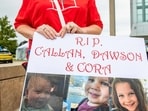 A woman carries a sign to show support for the three murdered children of Lindsay Clancy during the Clancy's murder trial at Plymouth Superior Court in Plymouth, Massachusetts on September 1, 2026. (Photo by JOSEPH PREZIOSO / AFP)