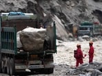 Trucks carrying stones are seen at the road clearing site as rescue personnel work to restore access to the mudslide-hit Gyirong Port in Gyirong County, in China's western Tibet Autonomous Region.