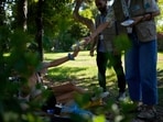 File photo: A woman living in a park receives cold water and a small hygiene kit from during heat wave in Athens, Greece