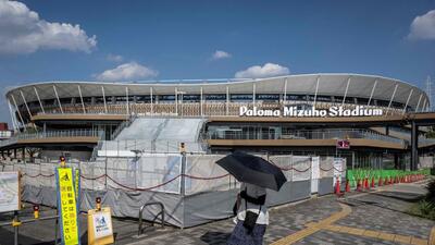 (FILES) This picture taken on September 7, 2025 shows a woman shielding herself from the hot sun with an umbrella as she walks past the Nagoya City Mizuho Park Athletic Stadium, the venue for track and field and marathon competitions in the upcoming 2026 Aichi-Nagoya Asian Games in Nagoya, Aichi prefecture. (Photo by Yuichi YAMAZAKI / AFP) (AFP) (FILES) This picture taken on September 7, 2025 shows a woman shielding herself from the hot sun with an umbrella as she walks past the Nagoya City Mizuho Park Athletic Stadium, the venue for track and field and marathon competitions in the upcoming 2026 Aichi-Nagoya Asian Games in Nagoya, Aichi prefecture. (Photo by Yuichi YAMAZAKI / AFP) (AFP)