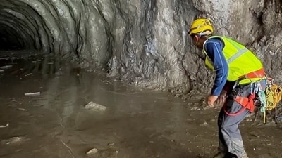 A rescuer works at the entrance of a tunnel at Chilime Hydropower Plant as rescue operations continue for people trapped inside following deadly flash floods and a mudslide, in Rasuwa, Nepal. (REUTERS)