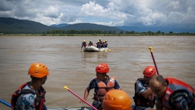 Members of the Armed Police Force (APF) conduct a search operation for bodies washed away by flash floods and a mudslide, in the Narayani River, Chitwan, Nepal. (REUTERS)
