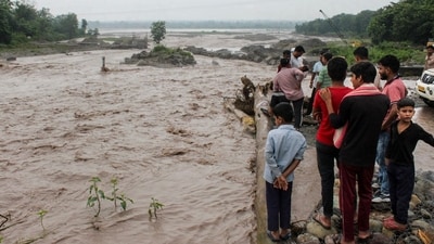 Rishikesh: People gather near an overflowing causeway as the swollen Bin river flows following incessant heavy rainfall, in Rishikesh, Uttarakhand on Tuesday, September 1. (PTI) Rishikesh: People gather near an overflowing causeway as the swollen Bin river flows following incessant heavy rainfall, in Rishikesh, Uttarakhand on Tuesday, September 1. (PTI)