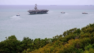 Tugboats prepare to guide US nuclear-powered aircraft carrier USS Abraham Lincoln (CVN-72) (C) towards Laem Chabang Port, near the city of Pattaya. (AFP) Tugboats prepare to guide US nuclear-powered aircraft carrier USS Abraham Lincoln (CVN-72) (C) towards Laem Chabang Port, near the city of Pattaya. (AFP)