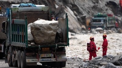 Trucks carrying stones are seen at the road clearing site as rescue personnel work to restore access to the mudslide-hit Gyirong Port in Gyirong County, in China's western Tibet Autonomous Region. (AFP) Trucks carrying stones are seen at the road clearing site as rescue personnel work to restore access to the mudslide-hit Gyirong Port in Gyirong County, in China's western Tibet Autonomous Region. (AFP)