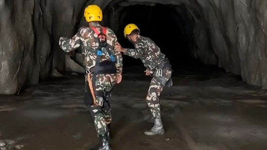 Nepali soldiers conducting an operation inside a tunnel to rescue workers after flash floods at the Rasuwagadhi Hydropower Project site in Rasuwa district.