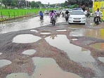 Potholes on the road near Sadar Tehsil in Gomti Nagar Extension-6 after heavy rainfall in Lucknow on Wednesday.