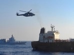 An Italian military helicopter flies above the oil tanker Toa Payoh, foreground, as the Italian Navy ship Thaon di Revel sails during an inspection by the European Union's mission west of the Italian island of Pantelleria, on August 2. Italy said the EU-sanctioned tanker declared it was sailing under a Cameroon flag and described it as part of Russia’s so-called “shadow fleet”. (REUTERS)