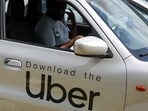 A Nigerian ride-hailing driver working with Uber sits inside his car and prepares to go offline.