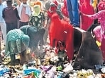 Sanitation workers obstructing movement of a JCB removing garbage in Rohtak on Wednesday. (HT Photo)