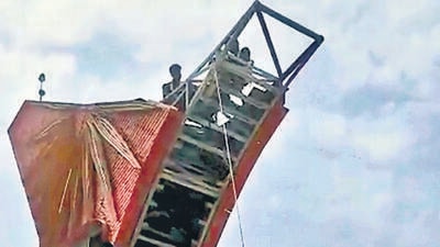 Enf of an era: Workers defy high winds to break down iconic Air India logo