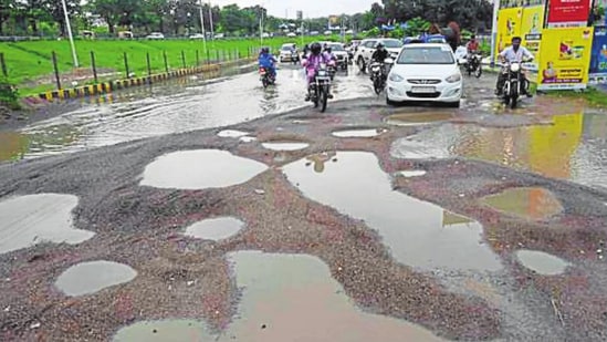 Potholes on the road near Sadar Tehsil in Gomti Nagar Extension-6 after heavy rainfall in Lucknow on Wednesday.